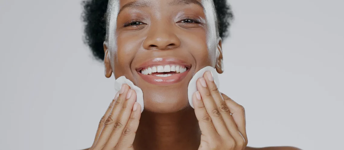 Woman applying toner to her skin